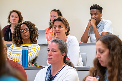 A group of Summer Institute audience members listening to a presentation