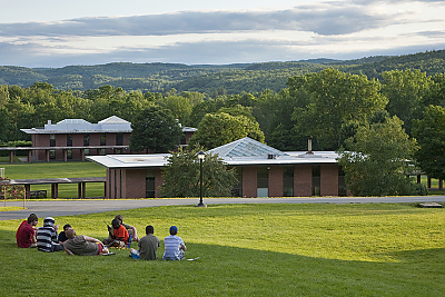 Landmark College students sitting on the upper campus green during the summer.