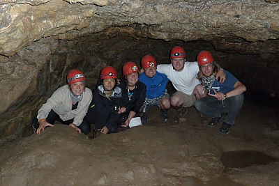 Landmark College students posing with their helmets after doing some caving