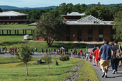 View of Landmark College upper campus with student traveling down the hill in a line. 