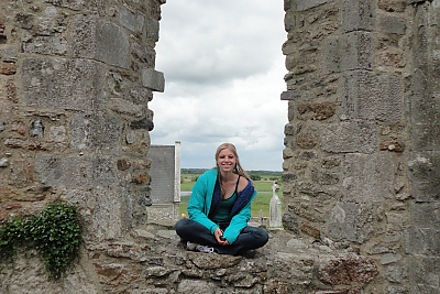 Landmark College student sitting in an archway at Clonmacnoise
