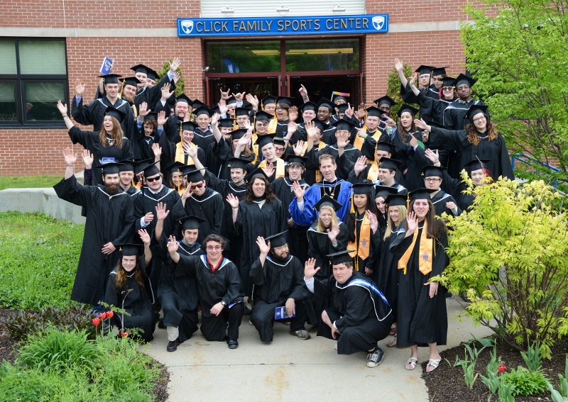 Spring 2015 graduates and Dr. Eden wave from in front of of Click Center