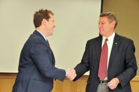 Dr. Eden and Ron Stahley shake hands after signing agreement