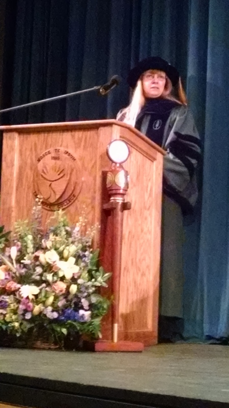 Dr. Kim Coleman speaks at podium during Convocation