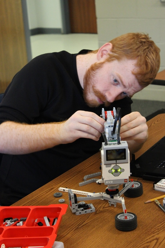 Male Landmark College student works on a robot in a Computer Science lab