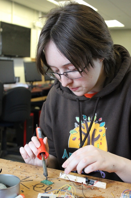 Female Landmark College student works on microchip 