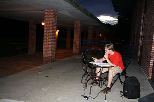 Student studying al fresco (library)