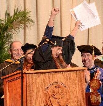 Graduate Crystal Kruse cheers as she accepts her Landmark College degree