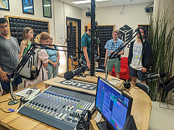 Students at a radio station broadcasting booth