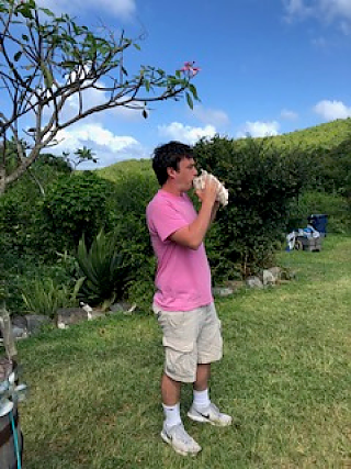 Ethan calling people to dinner on conch