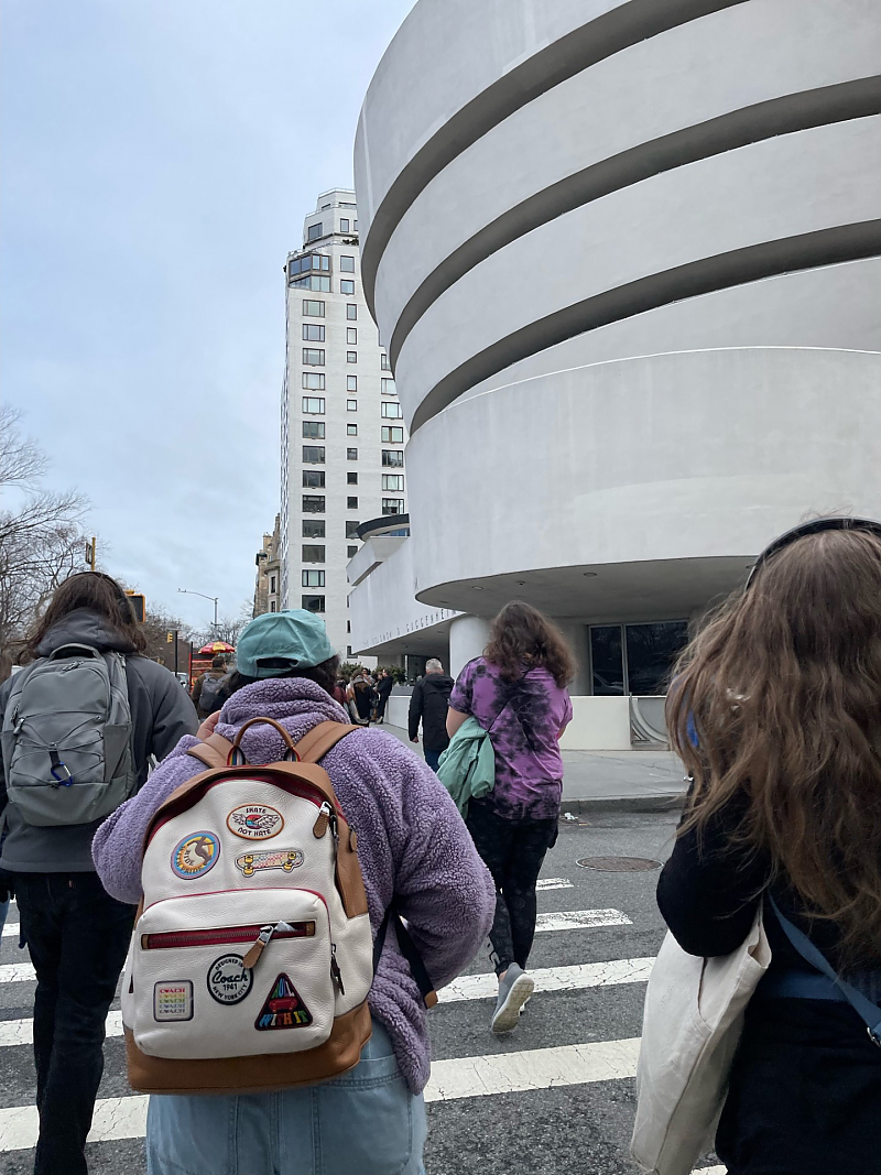 Group of students outside walking toward Guggenheim