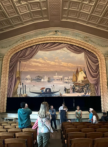 Students looking at painted curtain and stage