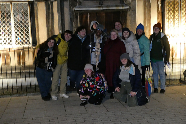 Students posing as a group outside front door of old house where Shakespeare lived.