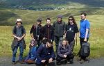 Students at the Summit of Lowther Hill overlooking the village of Wanlockhead, which can be seen in the distance behind them.  