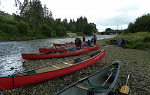 Students unloading canoes at the pick-up point on the River Clyde, Scotland
