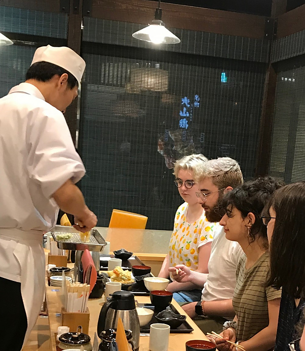 Students eating Japanese food in restaurant