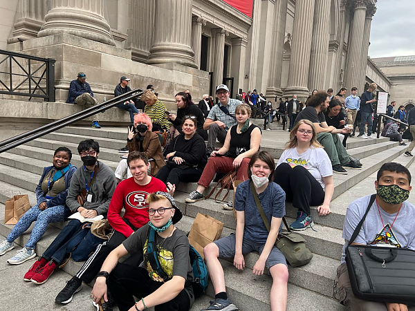 Group of students posing for photo on steps of the Met