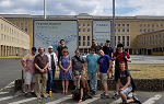 Students on the study abroad trip to Germany pose in front of a sign for the former Tempelhof Airfield.