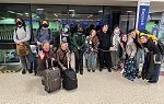 Group of students and faculty pose for a picture in Logan Airport, Boston before boarding a plane for London. 