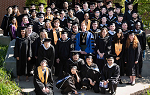 Group photo of Spring 2019 Graduating Class with Landmark College President Dr. Peter Eden, taken in front of the Click Family Athletic Center on May 18, 2019. 