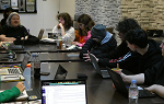 Table level photo of group of students having a discussion