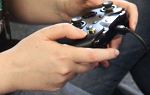 A close-up of hands holding a video game controller. 