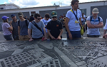 Students on the Summer 2018 Study Abroad trip to Germany look at a scale model of Sachsenhausen while visiting the site of the former Nazi concentration camp. 