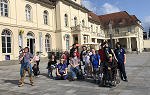 The students on the Germany Study abroad trip posing for a photo in a courtyard outside the building where they are staying.
