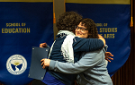 Student Laura Howard shares an embrace with faculty presenter Adrienne Major during the 2019 Academic Awards ceremony.