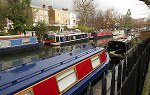 Several canal boats docked along an inlet in Little Venice