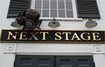 Next Stage sign above doors on building exterior