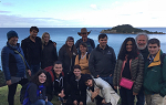 Students on the Summer 2018 Study Abroad trip to New Zealand pose for a picture with the ocean in the background. 