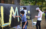 Students painting mural on campus
