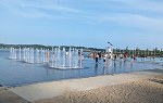 Image of three water fountains inside the infinity pool on Promenade Samuel de Champlain with several people wading around nearby