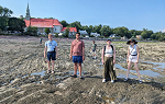 Students walking on the shore of the Saint Lawrence river.