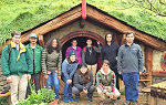Students on the Summer 2018 Study Abroad trip to New Zealand pose for a picture in front of one of the Hobbit Houses from the set of the 