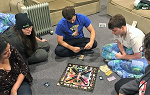Students on the Summer 2018 Study Abroad trip to New Zealand play Monopoly during a rainy day.