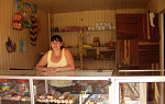 woman standing at counter of small shop