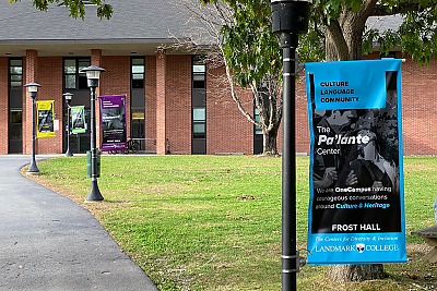 Image of Frost Hall with Pa' Lante Center banner in the foreground.