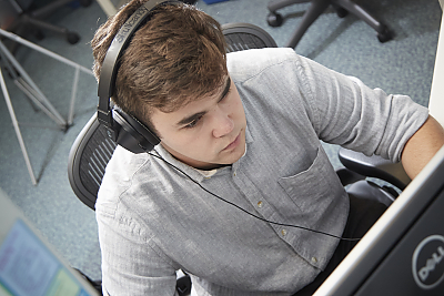 Young man working at a workstation with a computer. 