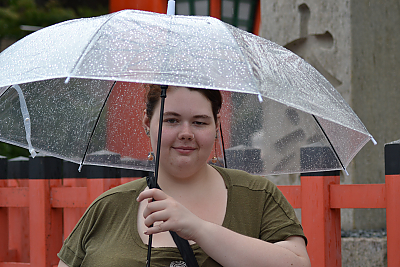 student with umbrella in the rain