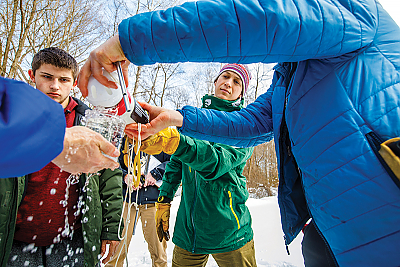 Landmark College students and professor conduct winter water ecology test 
