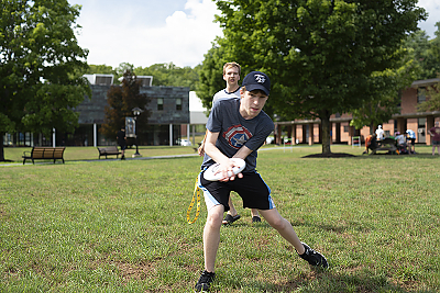 A boy catching a frisbee.