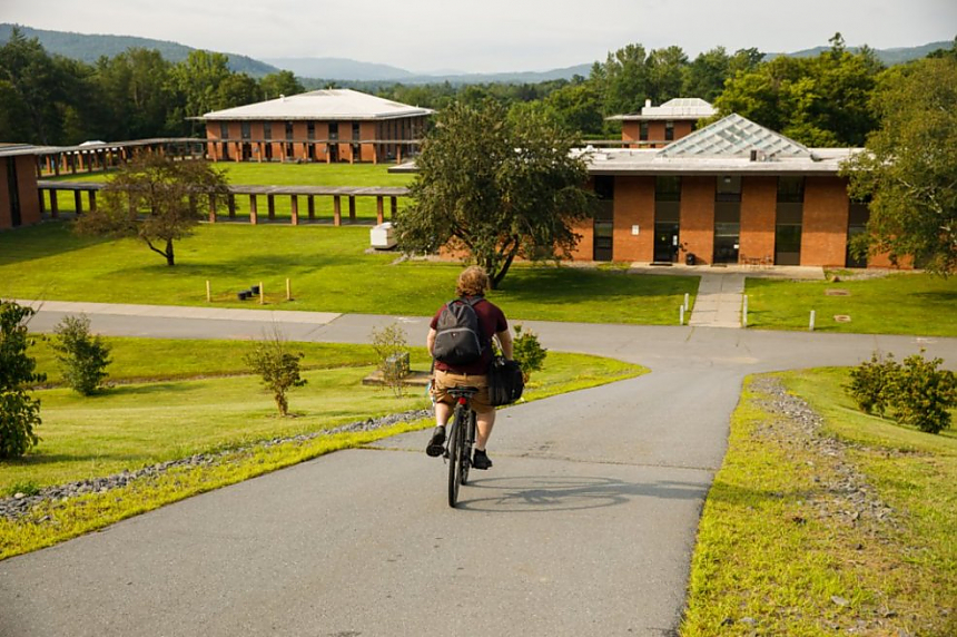 Landmark College student riding a bicycle on campus.