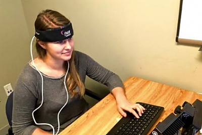 A student participates in a neuroimaging (fNIRS) study in a LCIRT research lab. 