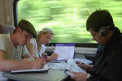 Students doing school work while riding on the train through Scotland