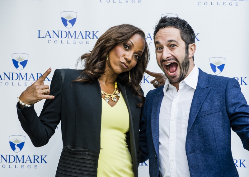 Holly Robinson Peete gestures and stands next to Aaron Wolf, who has an exuberant smile; Landmark College logo in background