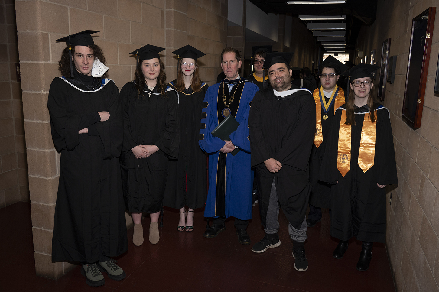 President Eden and a group of students posing for a photo at December 2023 graduation 