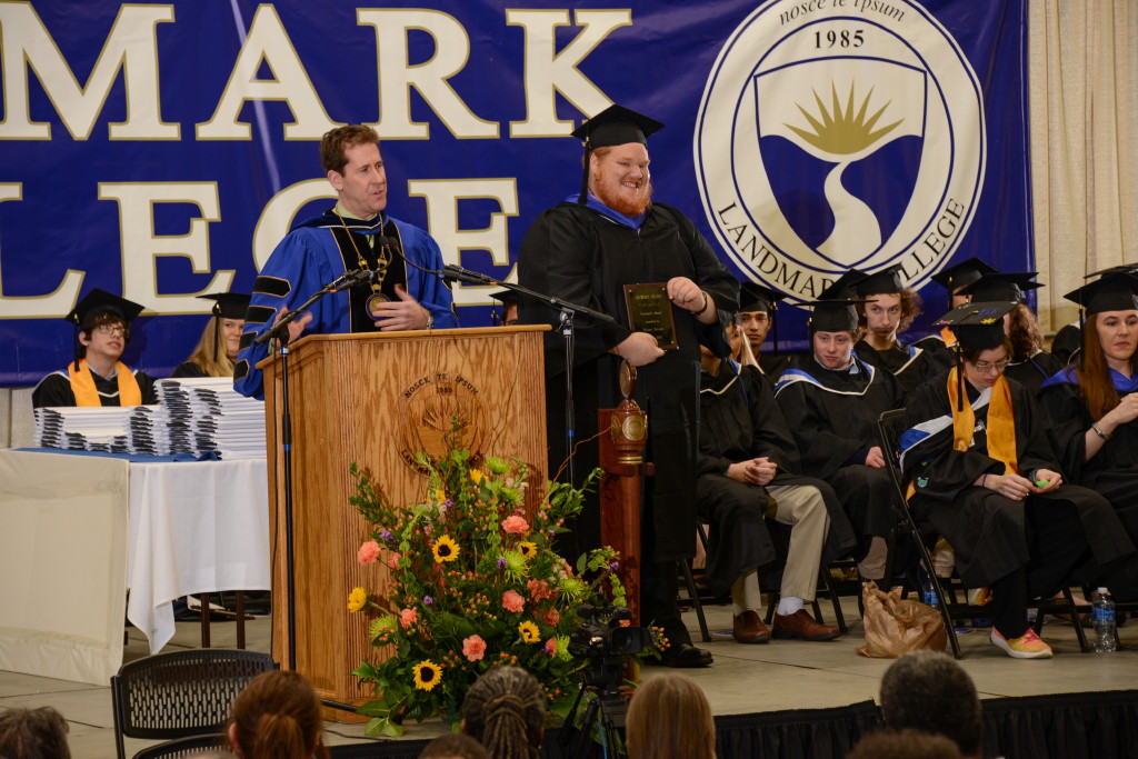 Michael Kenyon at podium with Peter Eden on graduation stage