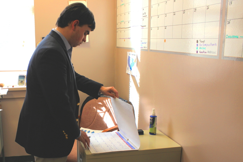William Epifanio looking at calendar in office
